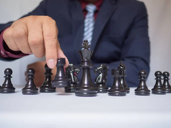 Businessman hand moving chess piece on board with white background, challenges planning business strategy to success concept — Stock Photo, Image