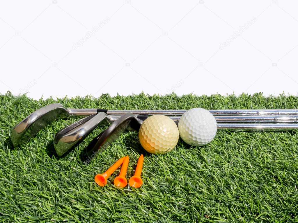 Golf essentials with artificial grass on white background