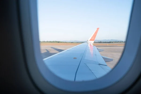 The picture of plane wing from the plane window view.