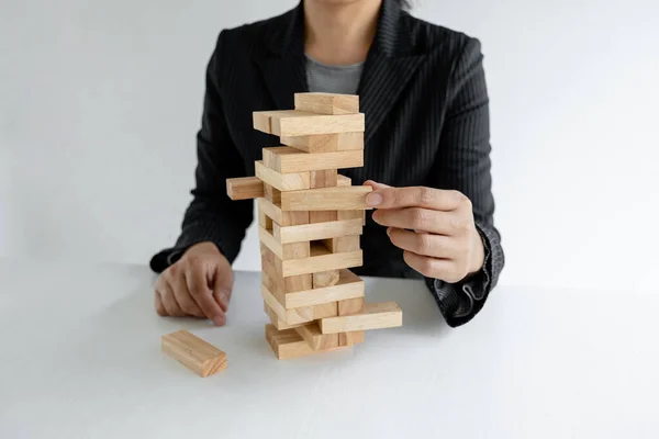 Hand holding blocks wood game, Concept Risk of management and strategy plan, growth business success process and team work.