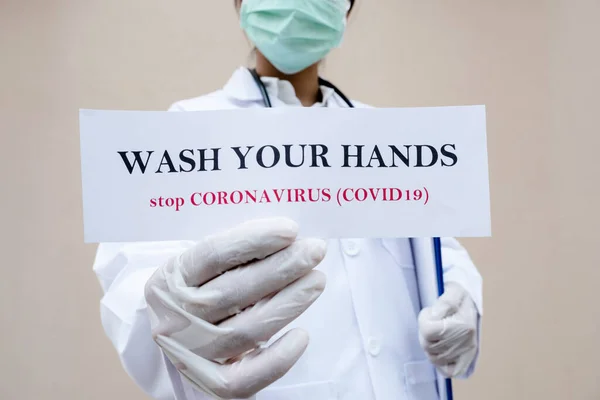Doctor holding the message, Wash Your Hands, stop coronavirus, covid-19.