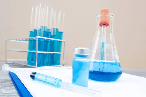 Picture of the experimenting the blue vaccine liquid with scientific equipment.
