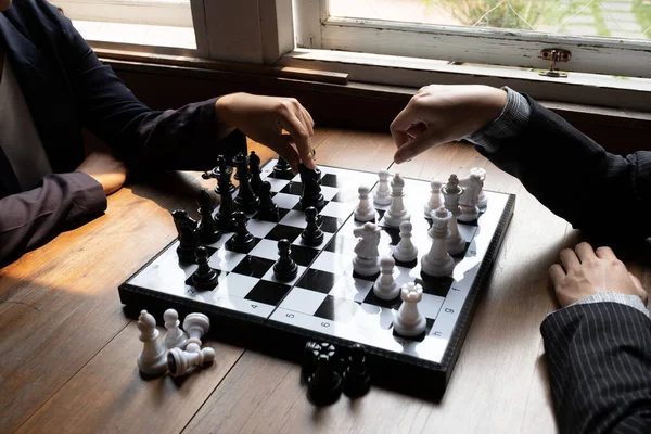 Business women play chess on board with white background, challenges planning business strategy to success concept.