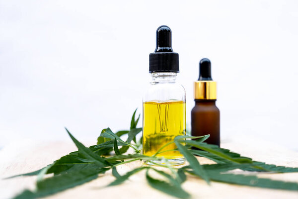 Hemp leaves and CBD oil. Alternative Medicine, Herbal Treatment concept.