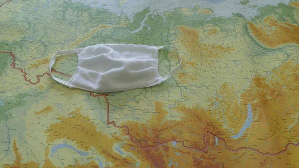 geographic map covered by a medical mask