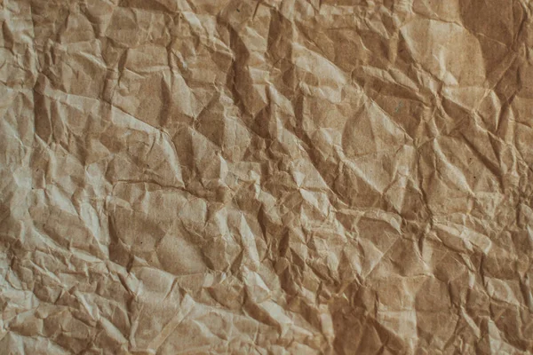 Textured crumpled Kraft paper. Brown texture.