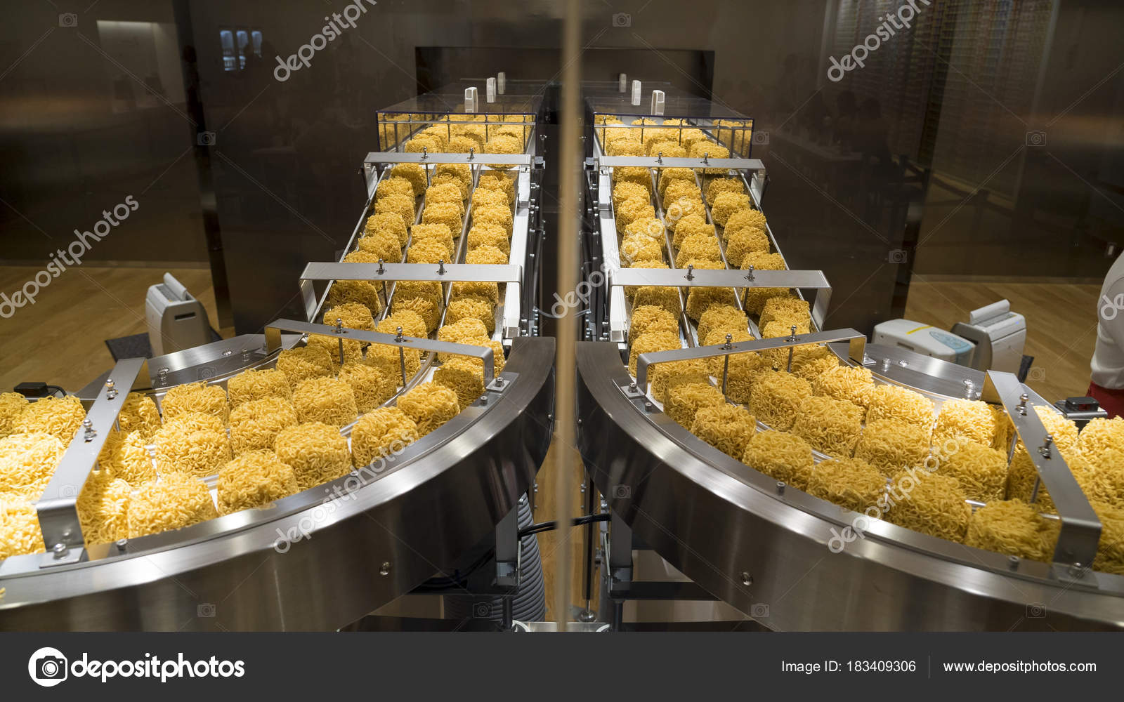 Instant noodles on conveyor belt in production process Stock Photo by