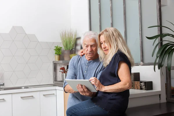 stock image senior couple looking at a tablet computer