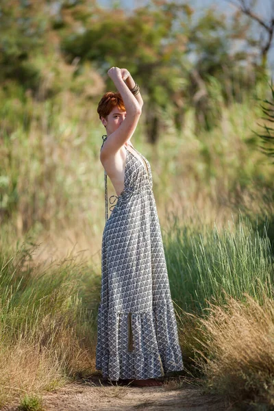 FREEDOM, WOMAN STANDING ARMS IN THE AIR OUTSID