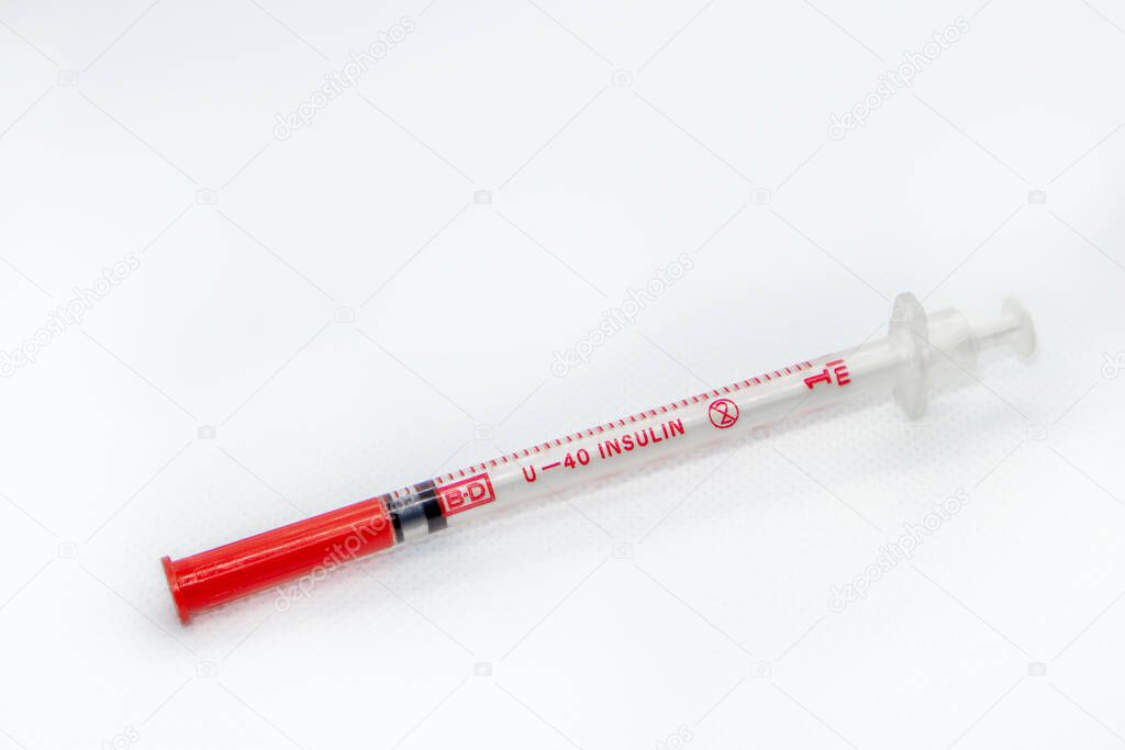 Insulin syringe diabetic close-up macro on white surface. Medicinal tool for injection, vaccine, cure