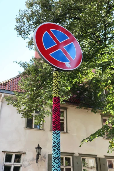 Street no parking warning traffic sign with knitting nice lovely city Riga Latvia Europe old city green trees and old building