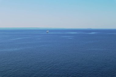 Güzel mavi deniz manzarası, küçük teknesi ve temiz bir arkaplanı var.