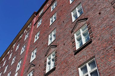 Kırmızı taş pencerelere tuğla örüyor Helsinki ev yapıyor