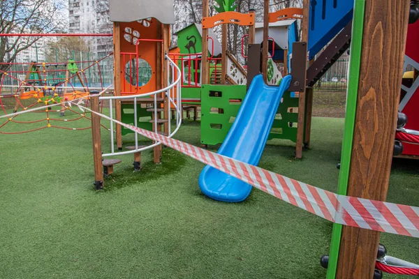 The Playground is closed. Playground without children, covered with safety tape. Quarantine.