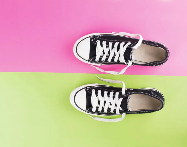 Pair of canvas shoes on two tone colorful background — Stock Photo, Image