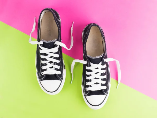 Pair of canvas shoes on two tone colorful background — Stock Photo, Image