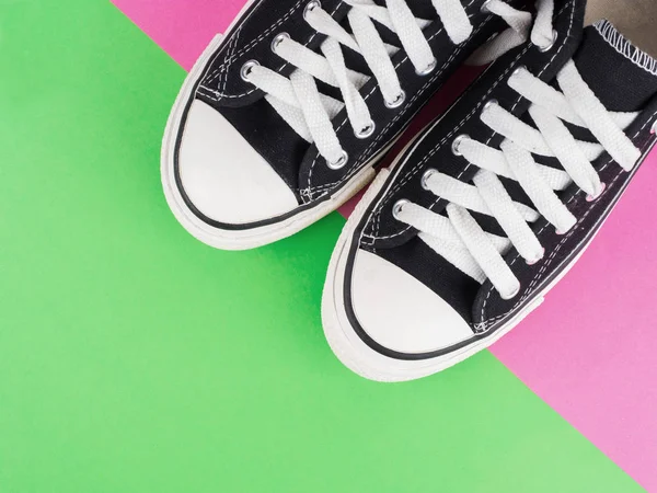 Pair of canvas shoes on two tone colorful background — Stock Photo, Image