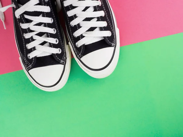 Pair of canvas shoes on two tone colorful background — Stock Photo, Image