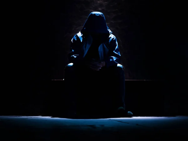 Unrecognizable man waiting on the dark room with single light so — Stock Photo, Image