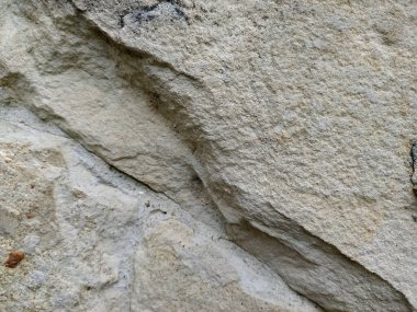 Gri taş duvar arkaplanı, mozaik taş duvar molozları ön cephe yakın doku çimento