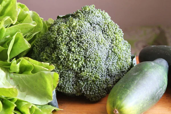 Whole Broccoli with Lettuce and Cucumber — Stock Photo, Image