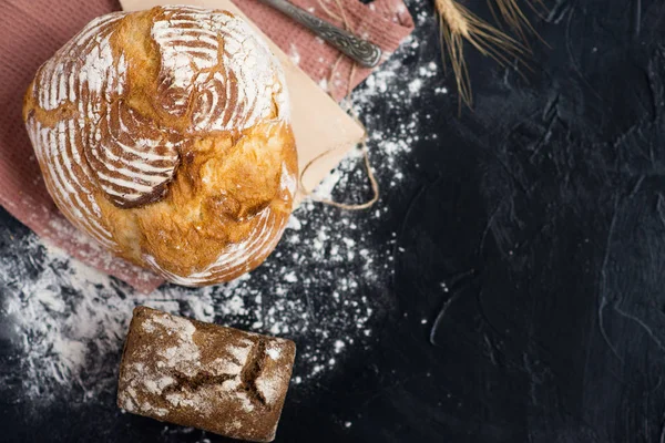 rustic rye bread on a black background