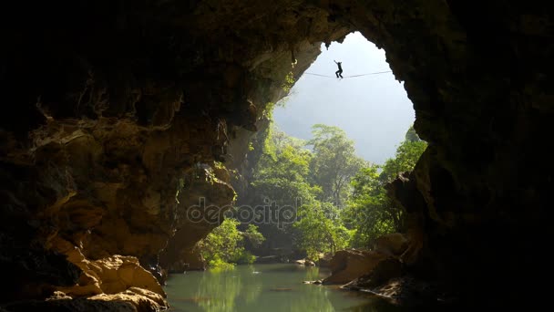 Tightrope walker in mountain cave — Stock Video