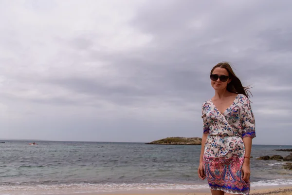 Das Mädchen im Sommerkleid am Strand — Stockfoto