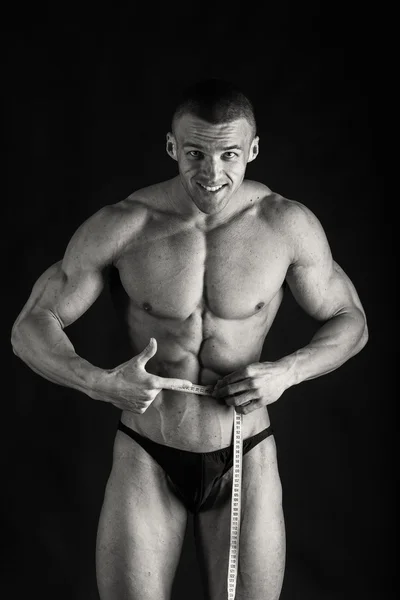 Bodybuilder in demonstrative poses on black — Stock Photo, Image