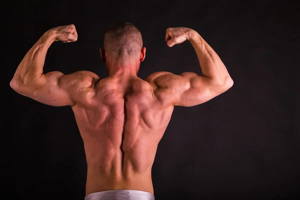 Bodybuilder emotivo su nero — Foto Stock