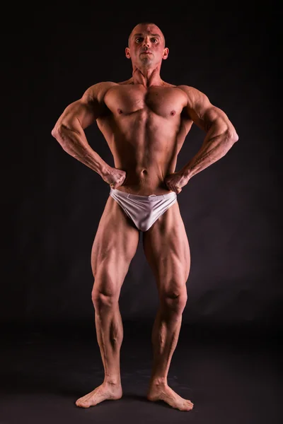Molto muscoloso bello atletico uomo su sfondo nero — Foto Stock