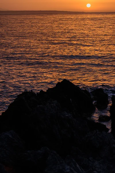 Schöner Sonnenuntergang am Abendmeer, Felsen im Vordergrund — Stockfoto