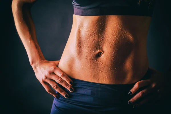 Chic, sexy belly girl on a dark background. Bright photos.