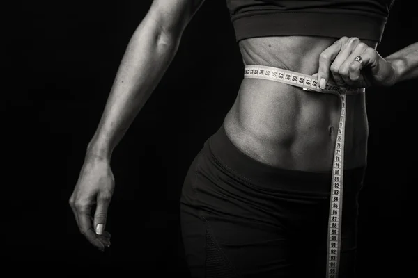 Sexy fitness woman on the black and white photo. — Stock Photo, Image