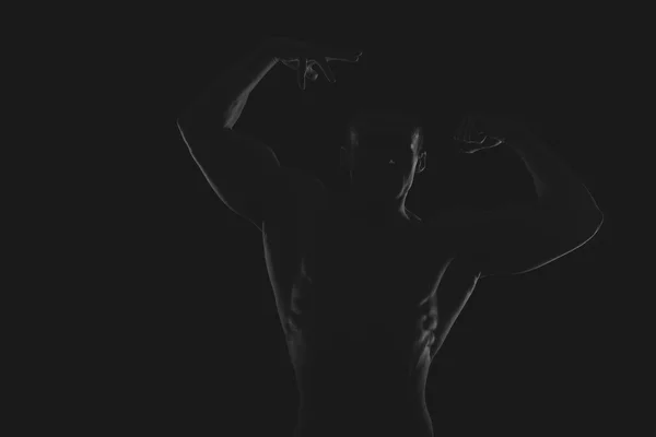 Silhouette of bodybuilder on the black and white photo. — Stock Photo, Image