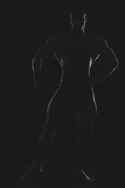 Silhouette di bodybuilder sulla foto in bianco e nero . — Foto Stock