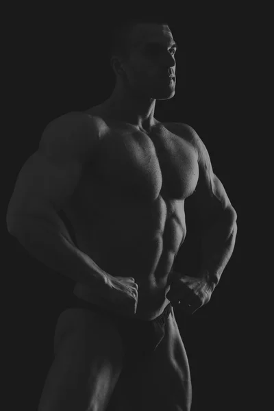 Silhouette of bodybuilder on the black and white photo. — Stock Photo, Image
