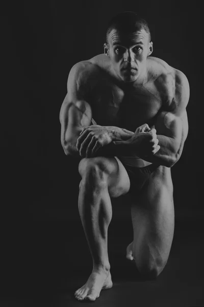 Grote bodybuilder op een donkere achtergrond — Stockfoto