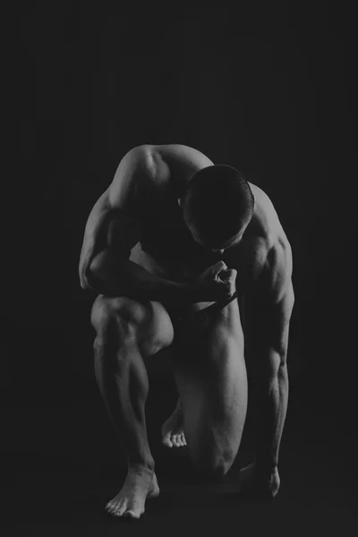 Big bodybuilder on a dark background — Stock Photo, Image