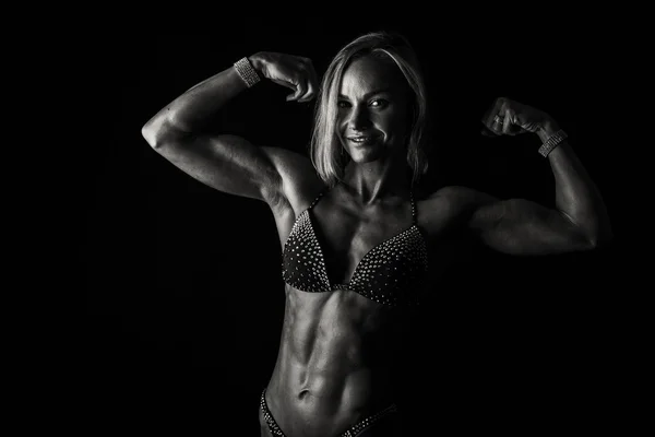 Sexy fitness woman on a dark background. — Stock Photo, Image