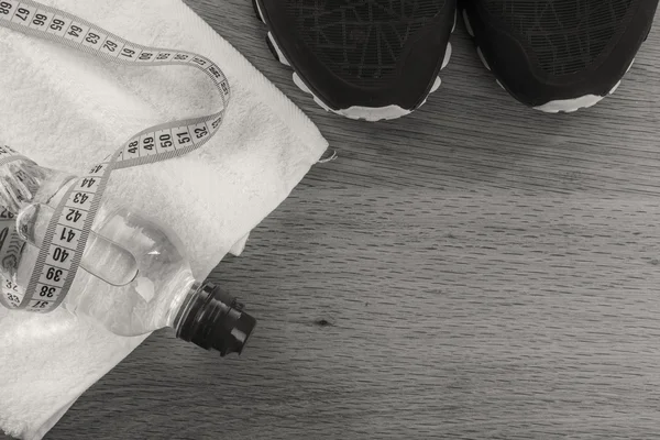 Fitness equipment on a table on a black and white photo. — Stock Photo, Image