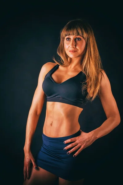 Sexual sports girl on a dark background. — Stock Photo, Image