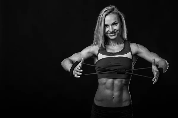 Female fitness on a dark background. — Stock Photo, Image