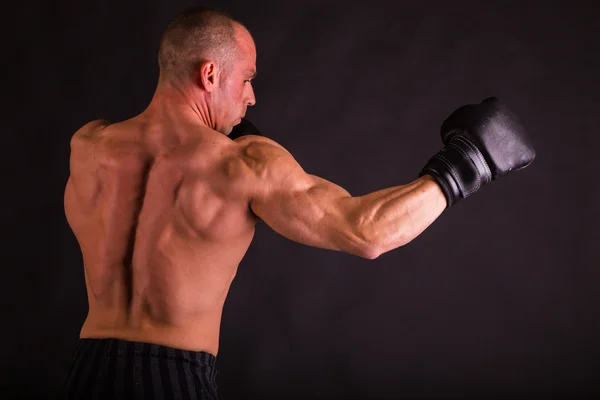 Uomo muscoloso in guanti da boxe — Foto Stock