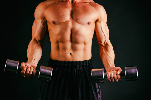Bodybuilder in boxing gloves on black