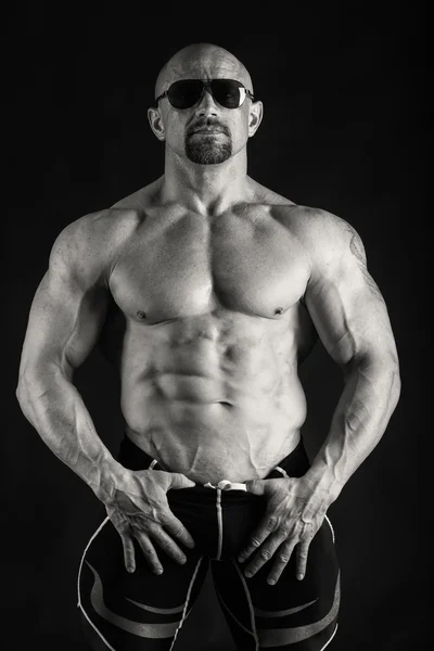 Elegant, muscular male body on black background — Stock Photo, Image