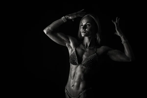 Sexy fitness woman on a dark background. — Stock Photo, Image