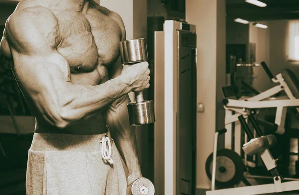 Handsome muscular guy in the gym