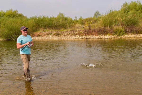 Jonge man visserij. Vissen op de rivier van de berg. Vissen op forel. — Stockfoto