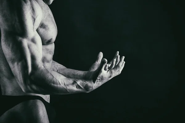 Men's muscles on a black background — Stock Photo, Image